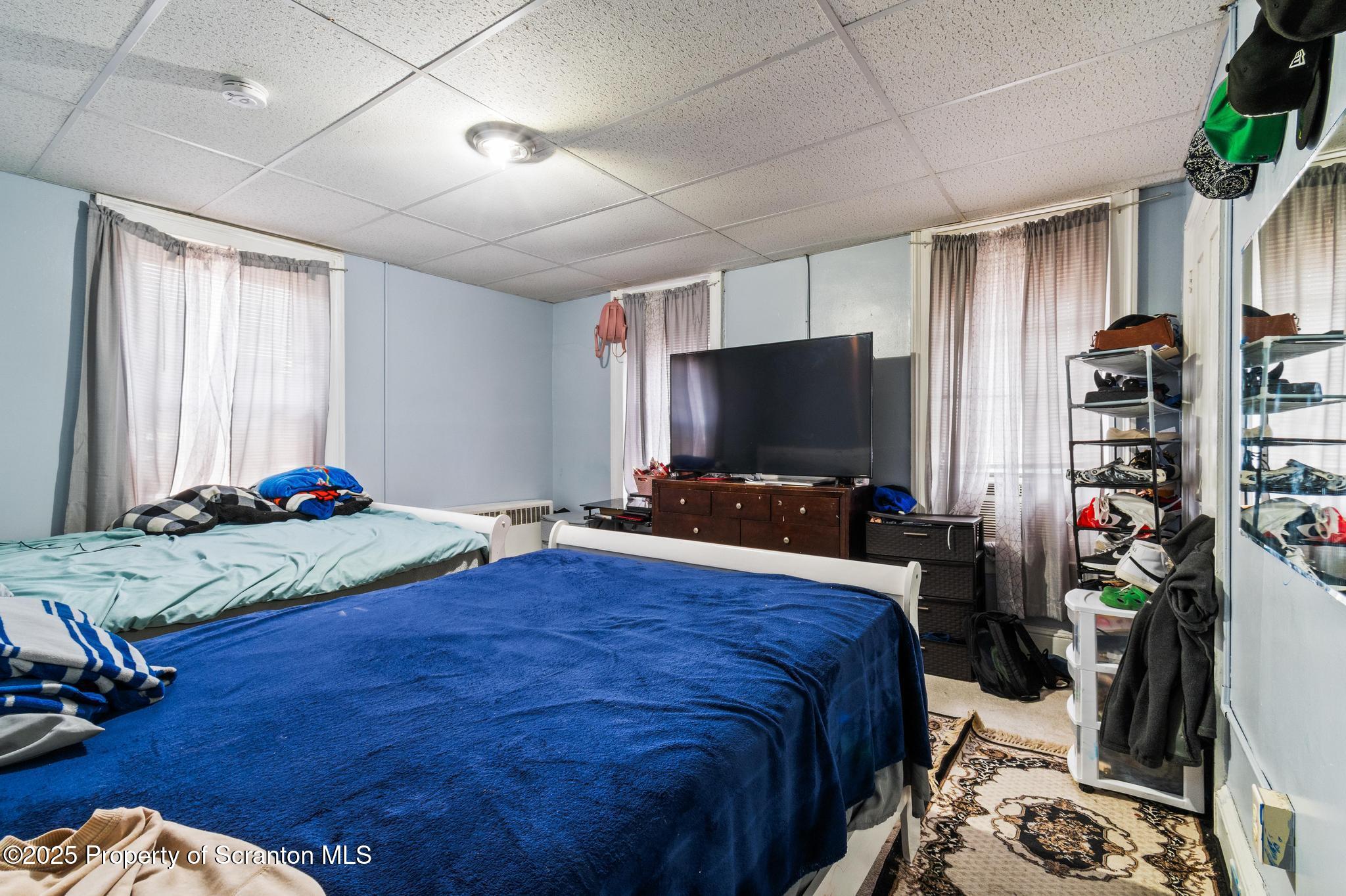 501-503 Cedar Avenue Scranton, PA 18505 - Photo 8 of 13 a bedroom with a bed and a flat screen tv