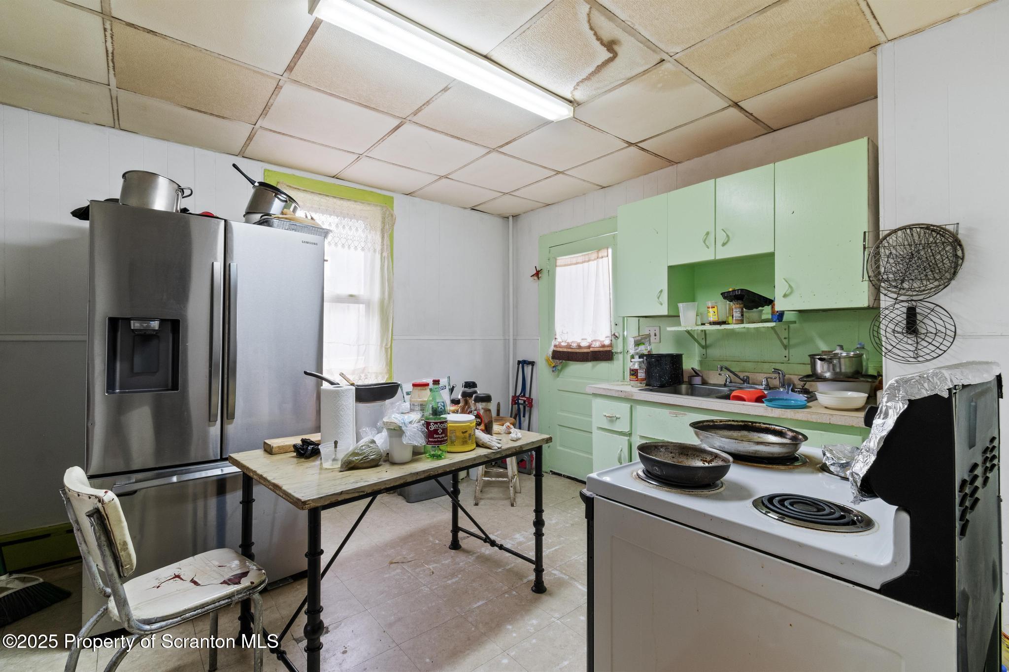 501-503 Cedar Avenue Scranton, PA 18505 - Photo 9 of 13 a kitchen with a refrigerator and a stove