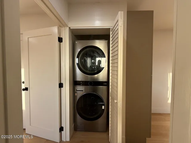 a view of a hallway with washer and dryer