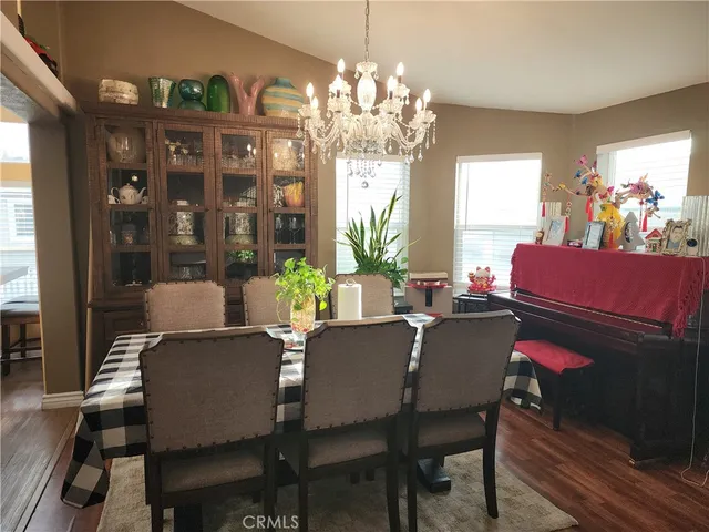 a dining room with furniture a chandelier and window