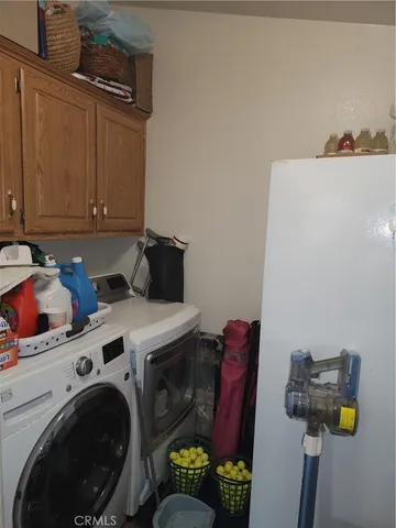 a utility room with dryer washer and other items