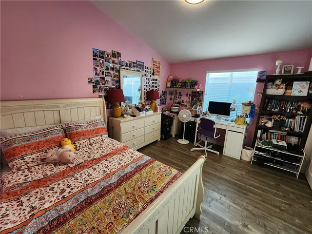 a bed room with a bed and a television