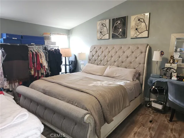 a bedroom with bed and cupboard