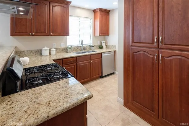 a kitchen with wooden cabinets and a stove top oven