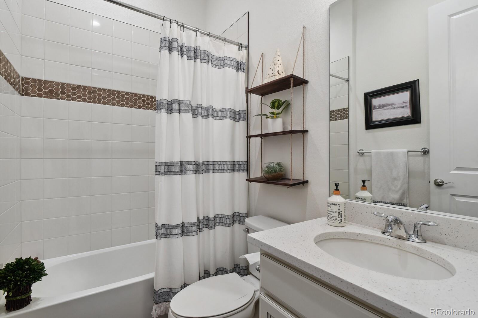 328 Simmental Loop Castle Rock, CO 80104 - Photo 14 of 20 a bathroom with a sink toilet and shower