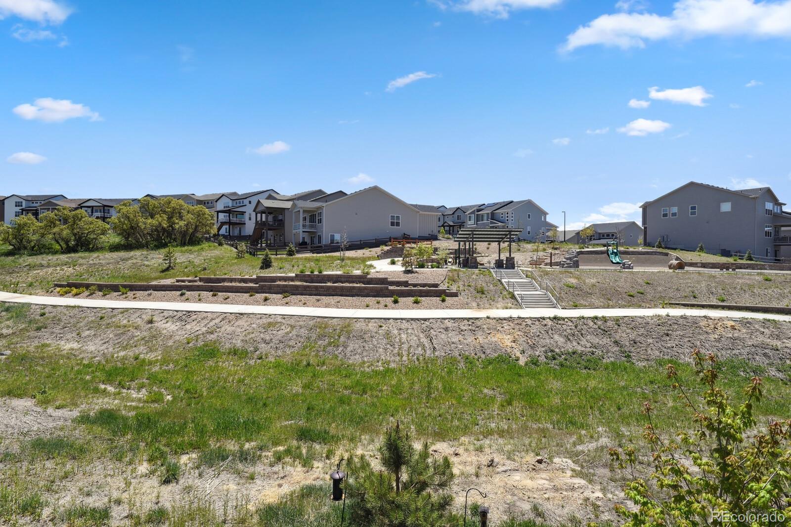 328 Simmental Loop Castle Rock, CO 80104 - Photo 19 of 20 a view of an house with backyard and a mountain view