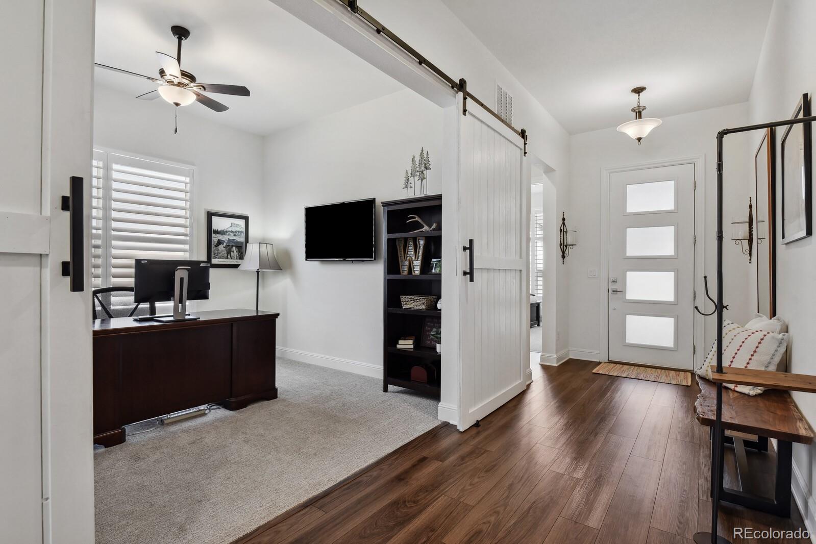 328 Simmental Loop Castle Rock, CO 80104 - Photo 3 of 20 a view of a kitchen with wooden floor and a kitchen