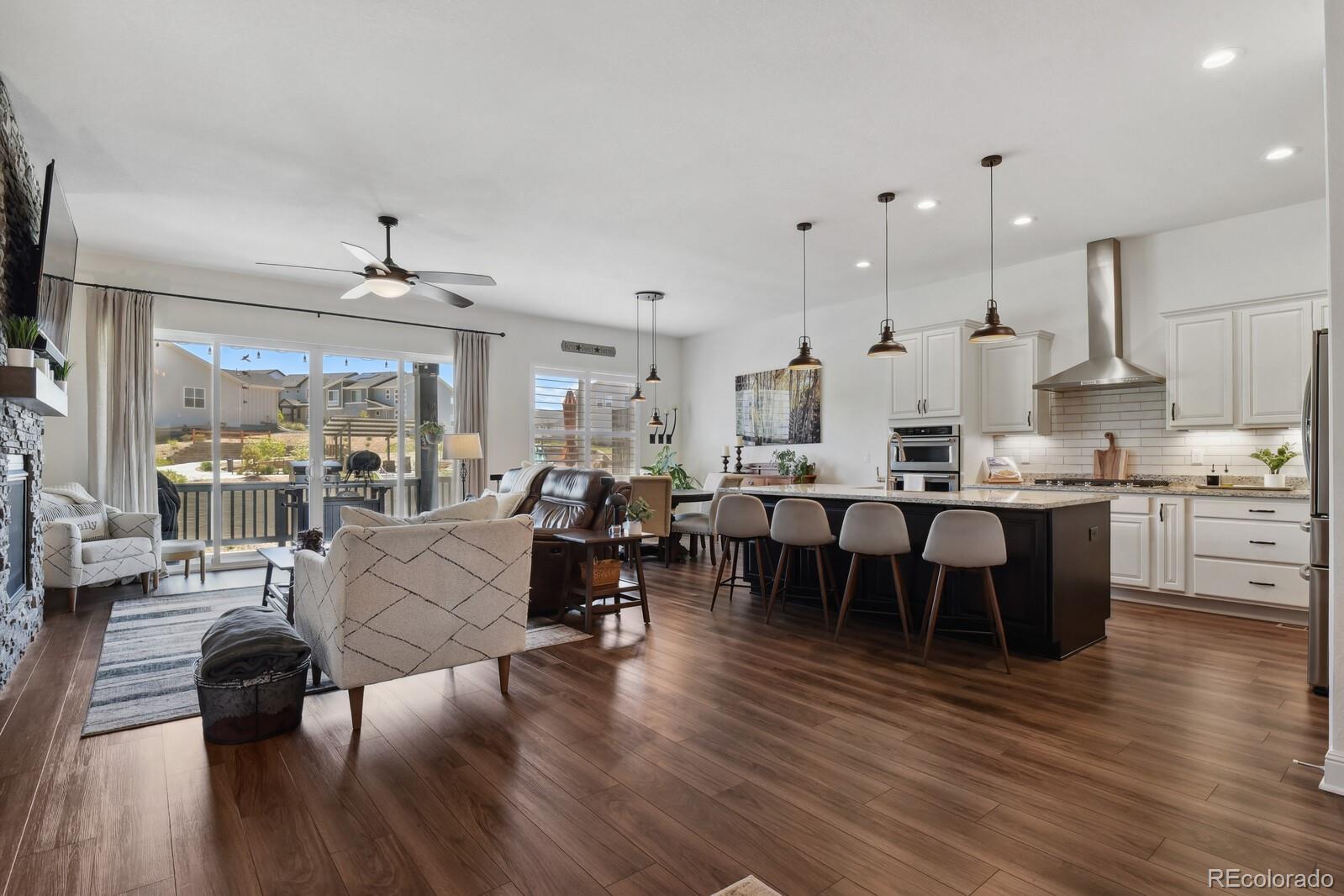 328 Simmental Loop Castle Rock, CO 80104 - Photo 4 of 20 a large kitchen with a table and chairs