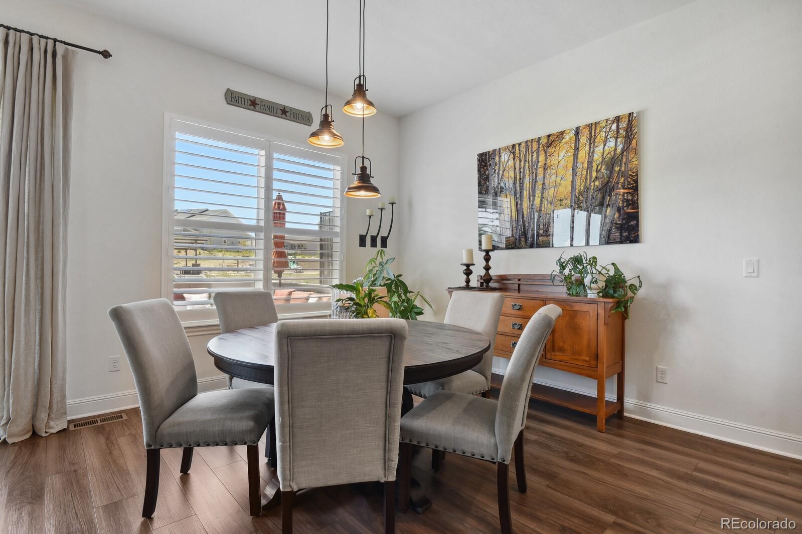 328 Simmental Loop Castle Rock, CO 80104 - Photo 6 of 20 a view of a dining room with furniture window and wooden floor