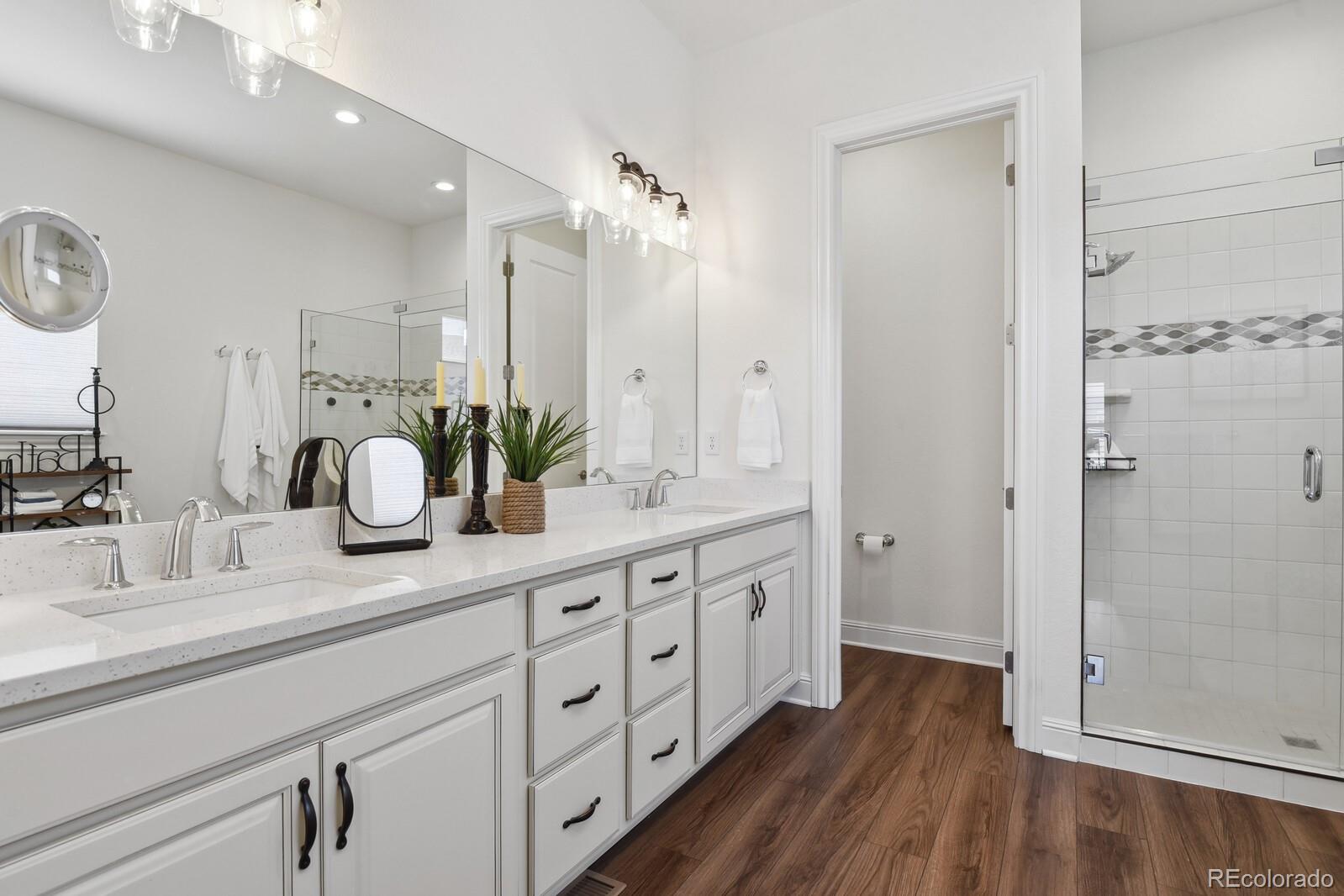 328 Simmental Loop Castle Rock, CO 80104 - Photo 9 of 20 a bathroom with double vanity sink and shower