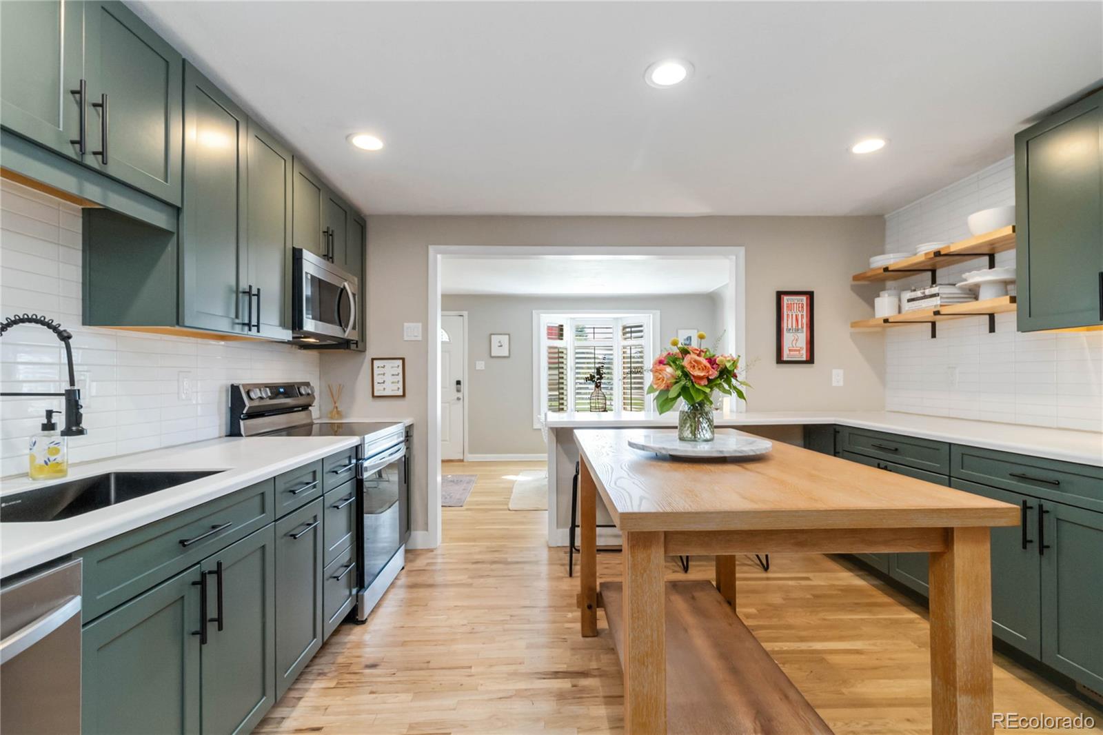 2701 Hooker Street Denver, CO 80211 - Photo 15 of 49 a kitchen with kitchen island a sink table and chairs