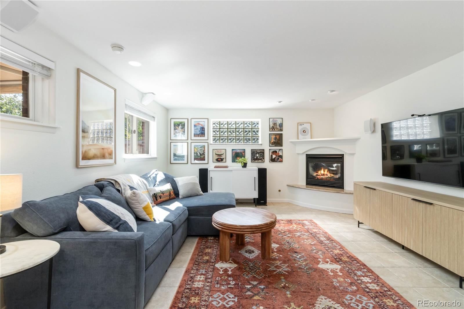 2701 Hooker Street Denver, CO 80211 - Photo 23 of 49 a living room with furniture a flat screen tv and a fireplace