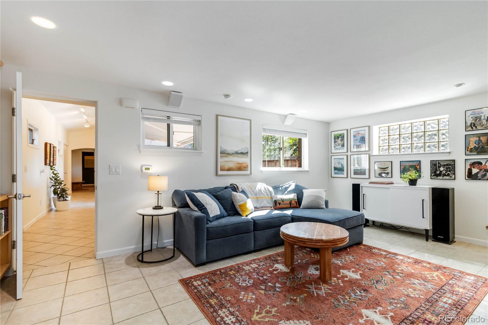 2701 Hooker Street Denver, CO 80211 - Photo 24 of 49 a living room with furniture a rug a lamp and windows