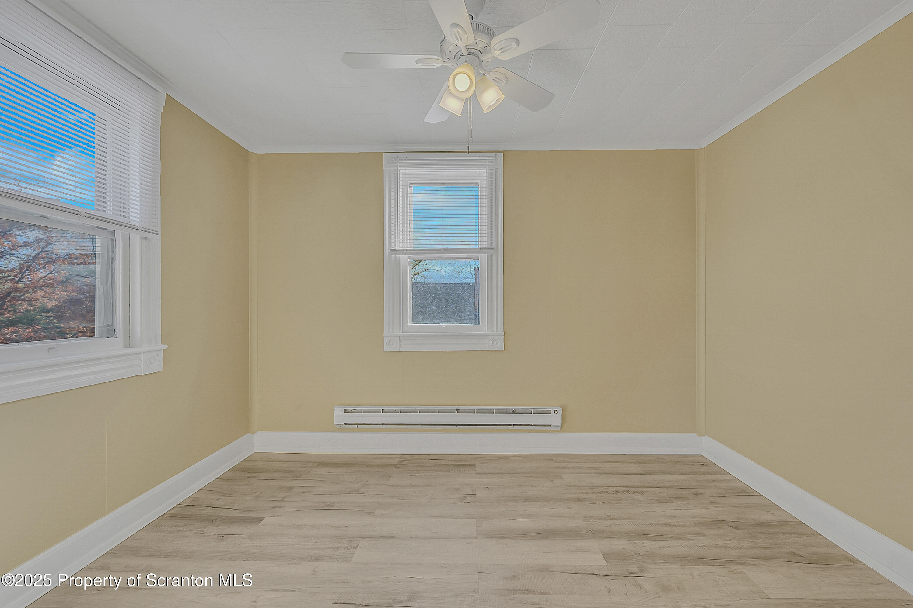 864 South Main Street, Unit 4 Old Forge, PA 18518 - Photo 11 of 17 a view of empty room with wooden floor and fan
