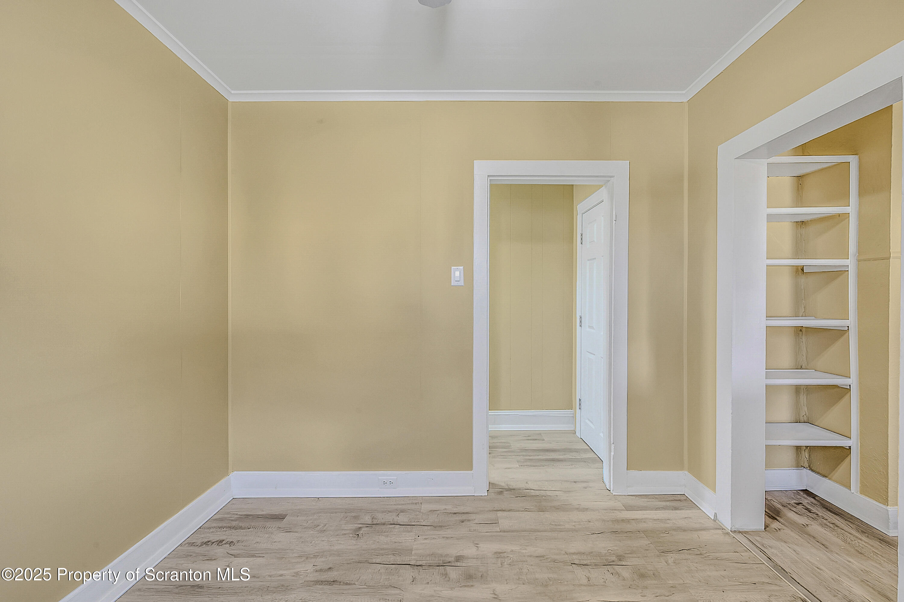 864 South Main Street, Unit 4 Old Forge, PA 18518 - Photo 7 of 17 a view of an empty room with wooden floor and closet
