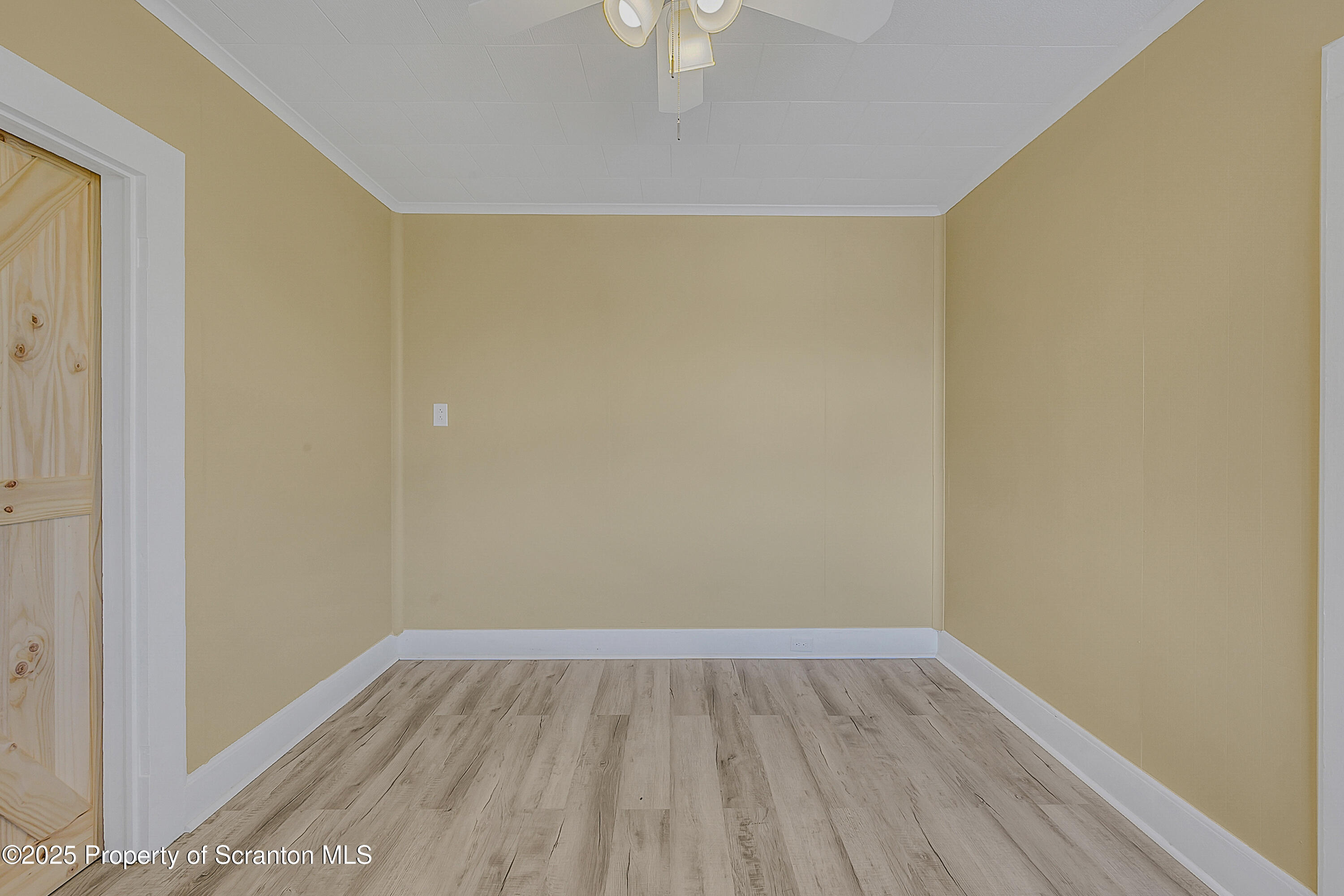 864 South Main Street, Unit 4 Old Forge, PA 18518 - Photo 9 of 17 a view of an empty room with wooden floor and a window