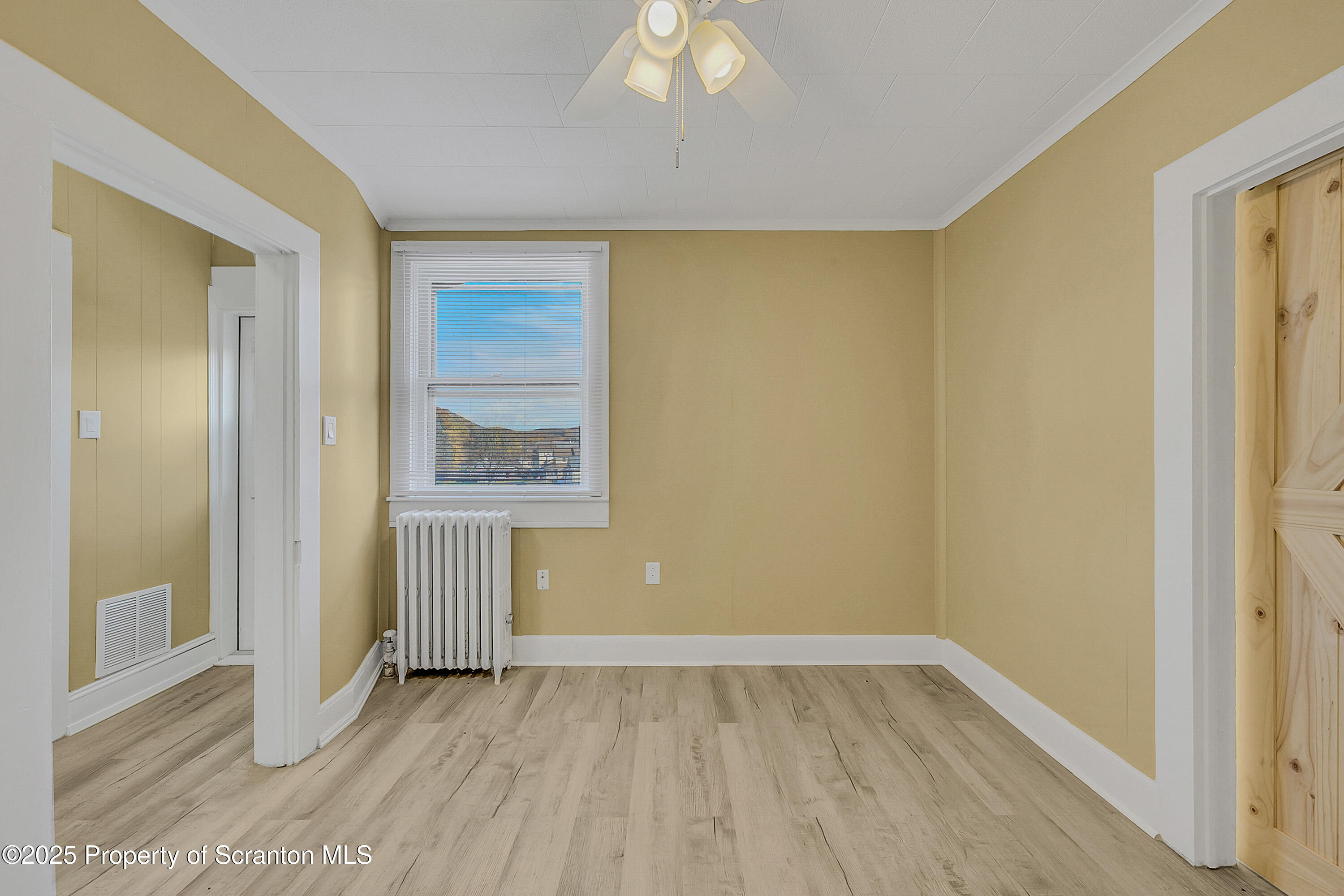 864 South Main Street, Unit 4 Old Forge, PA 18518 - Photo 10 of 17 a view of an empty room with wooden floor and a window