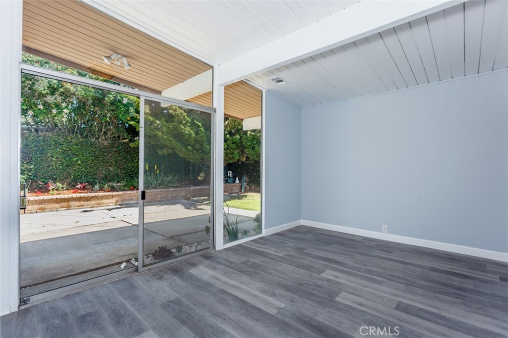 1747 North Shaffer Street Orange, CA 92865 - Photo 12 of 35 a view of an empty room with wooden floor and windows