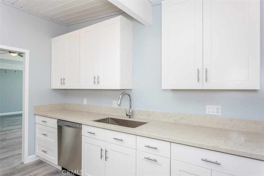 1747 North Shaffer Street Orange, CA 92865 - Photo 17 of 35 a kitchen with white cabinets and a sink