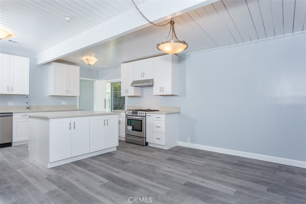 1747 North Shaffer Street Orange, CA 92865 - Photo 19 of 35 a kitchen with a white cabinets and wooden floor