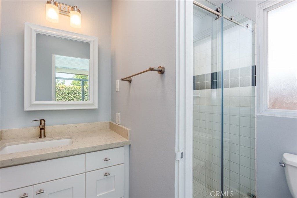 1747 North Shaffer Street Orange, CA 92865 - Photo 25 of 35 a bathroom with a shower sink and mirror