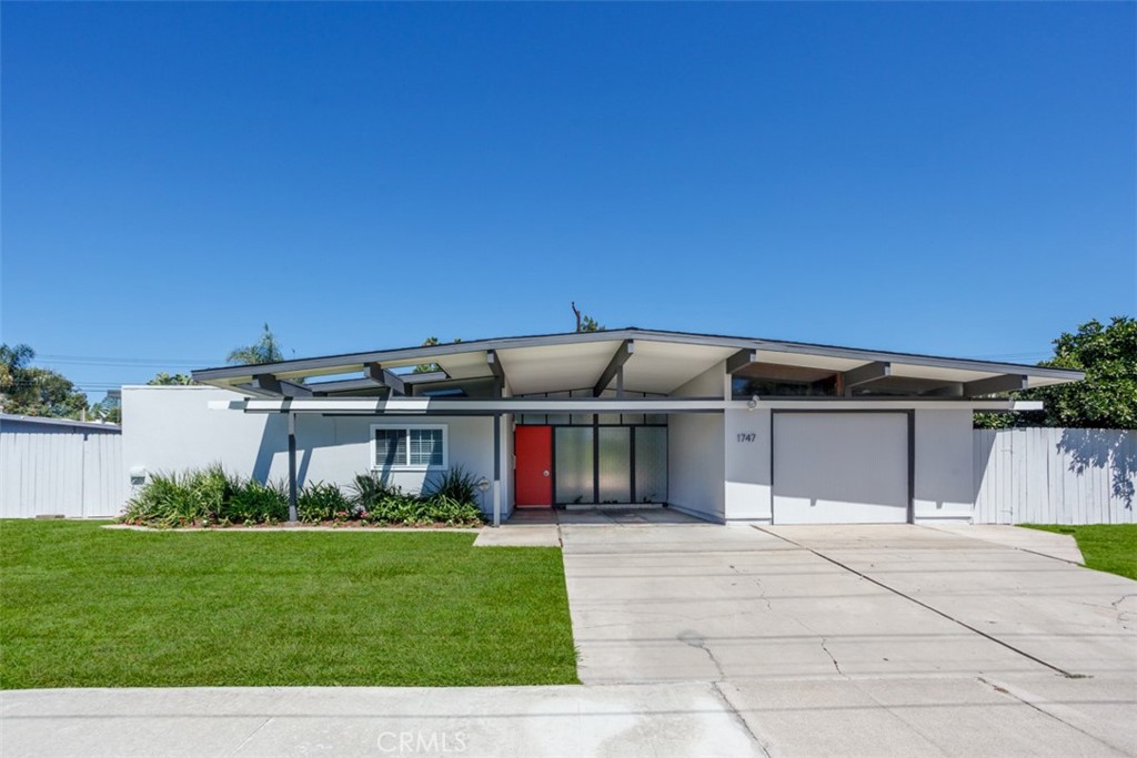 1747 North Shaffer Street Orange, CA 92865 - Photo 3 of 35 a front view of a house with a garden and plants