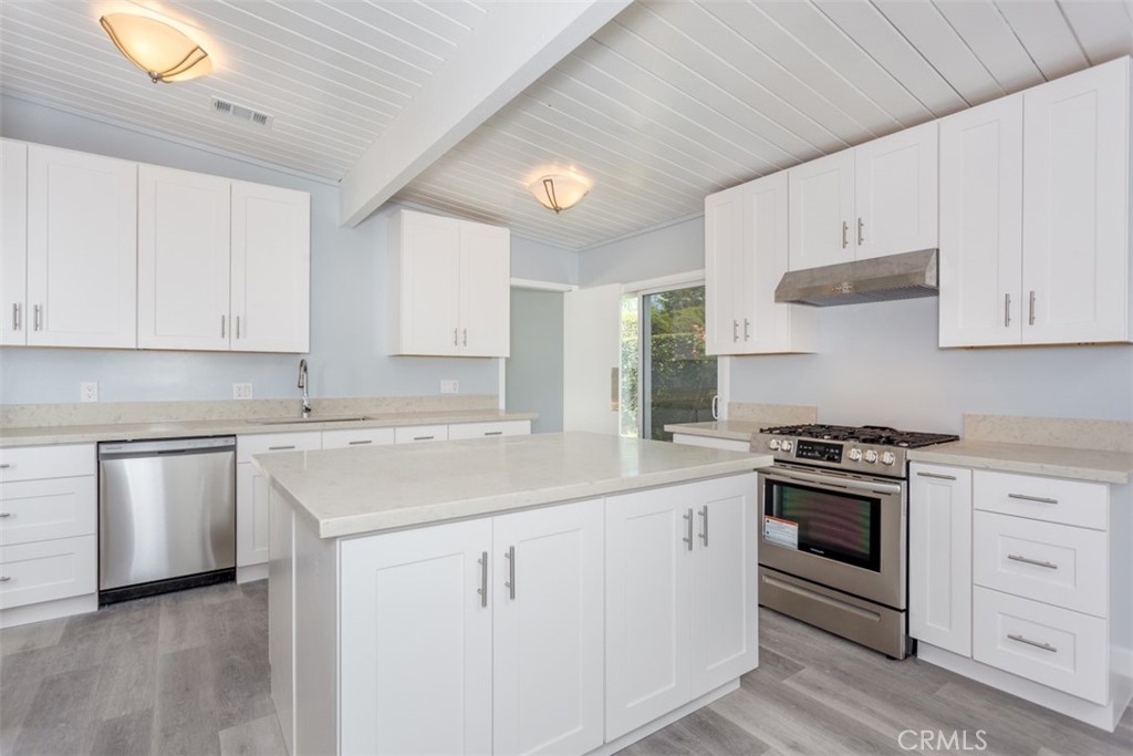 1747 North Shaffer Street Orange, CA 92865 - Photo 10 of 35 a kitchen with white cabinets stainless steel appliances and sink