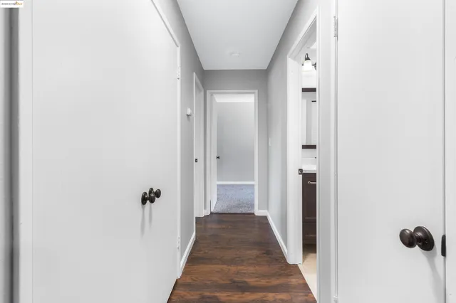 a view of a hallway with wooden floor