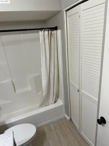 a bathroom with a shower curtain and a sink