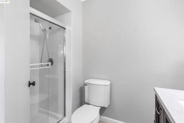 a white toilet sitting next to a bathroom