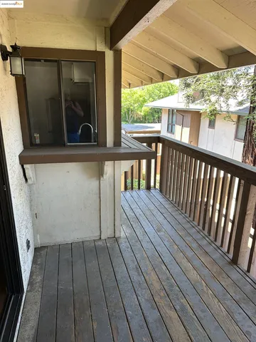 a view of balcony with wooden floor