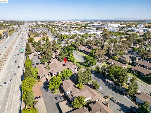 an aerial view of residential building and car parked