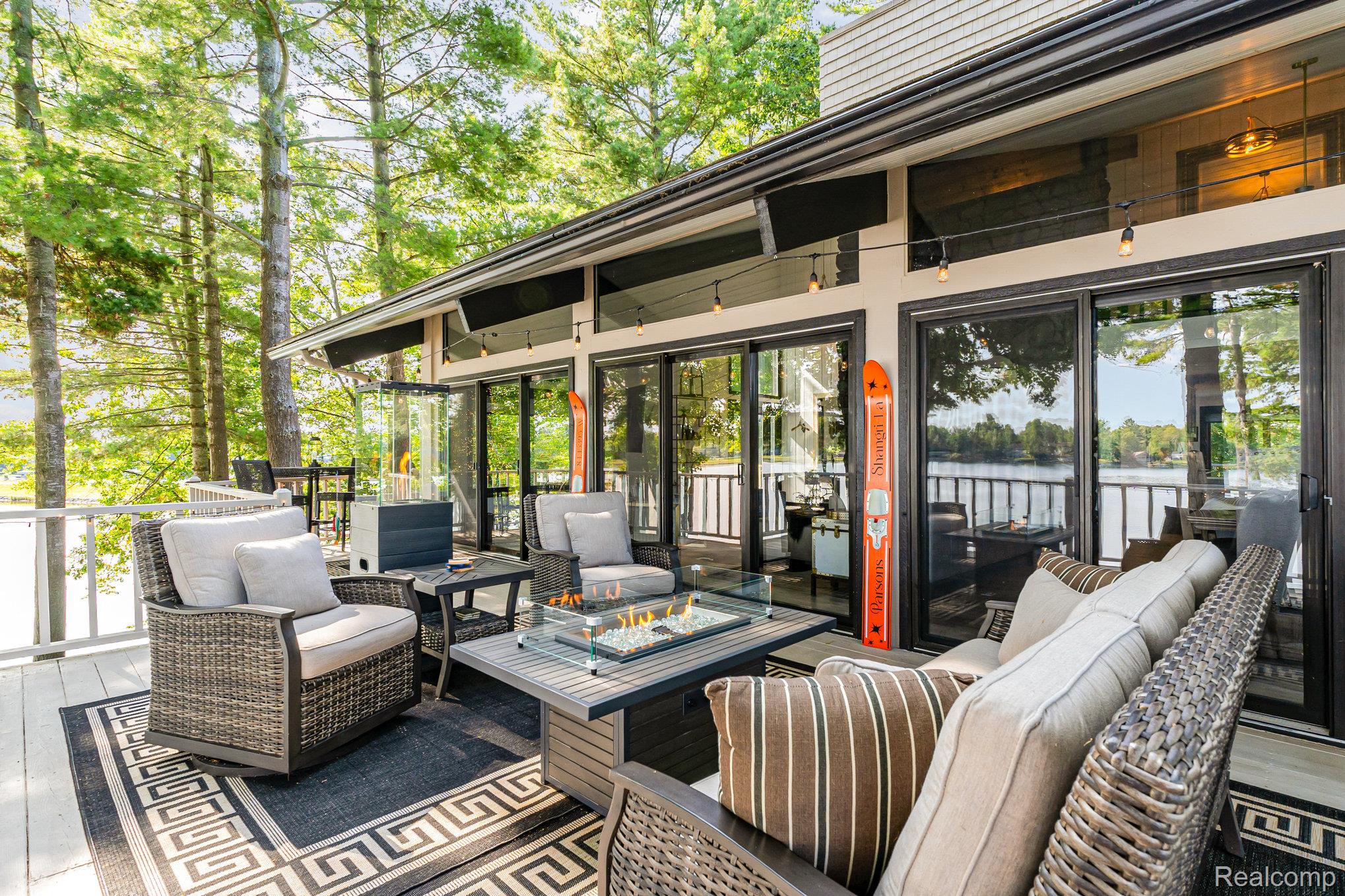 2380 Islanders Way Gladwin, MI 48624 - Photo 16 of 48 Wooden deck featuring an outdoor living space with a fire pit and a water view