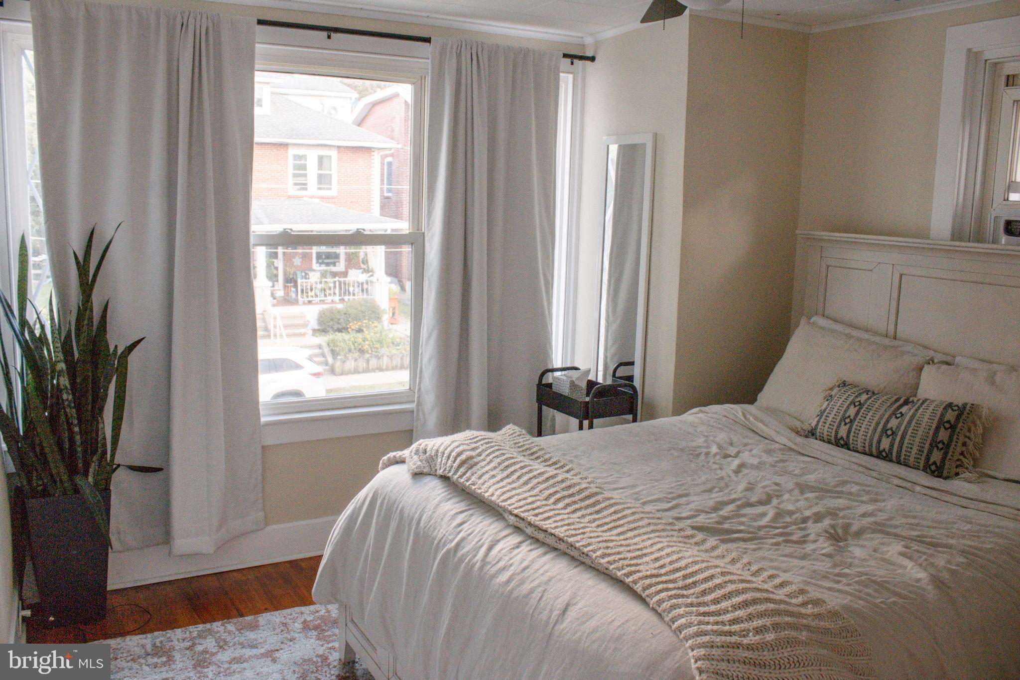 320 South Sterley Street Reading, PA 19607 - Photo 14 of 23 Serene bedroom with natural light and greenery.