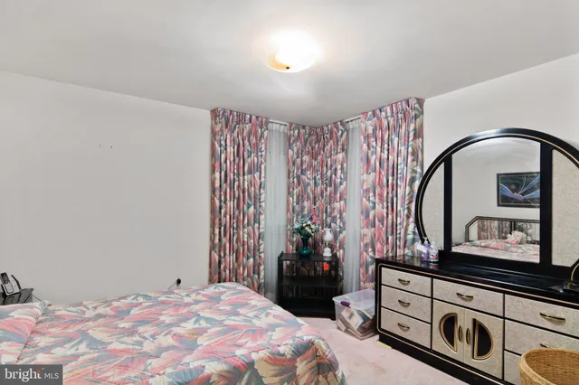 a bedroom with a bed and a mirror