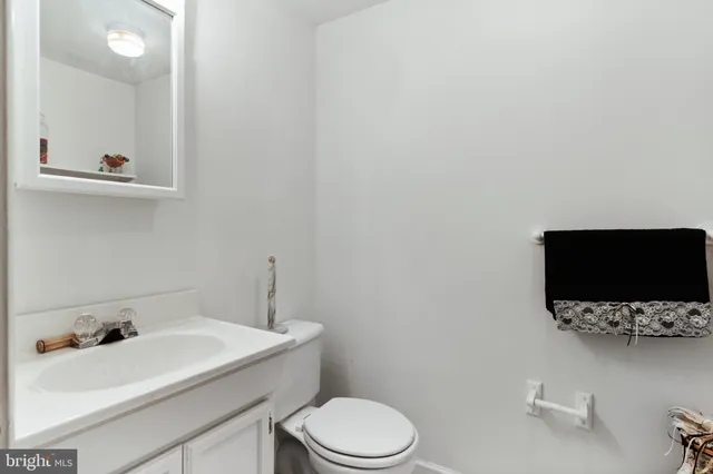 a bathroom with a sink toilet and mirror