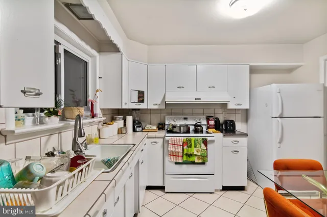 a kitchen with stainless steel appliances a stove a sink and a refrigerator
