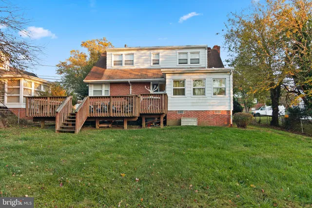 a view of a house with a yard and sitting area