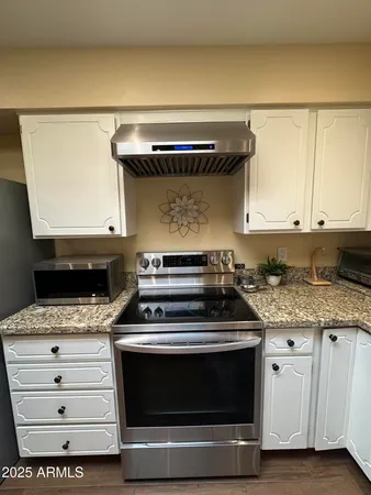 a open kitchen with stainless steel appliances granite countertop a stove a sink and cabinets