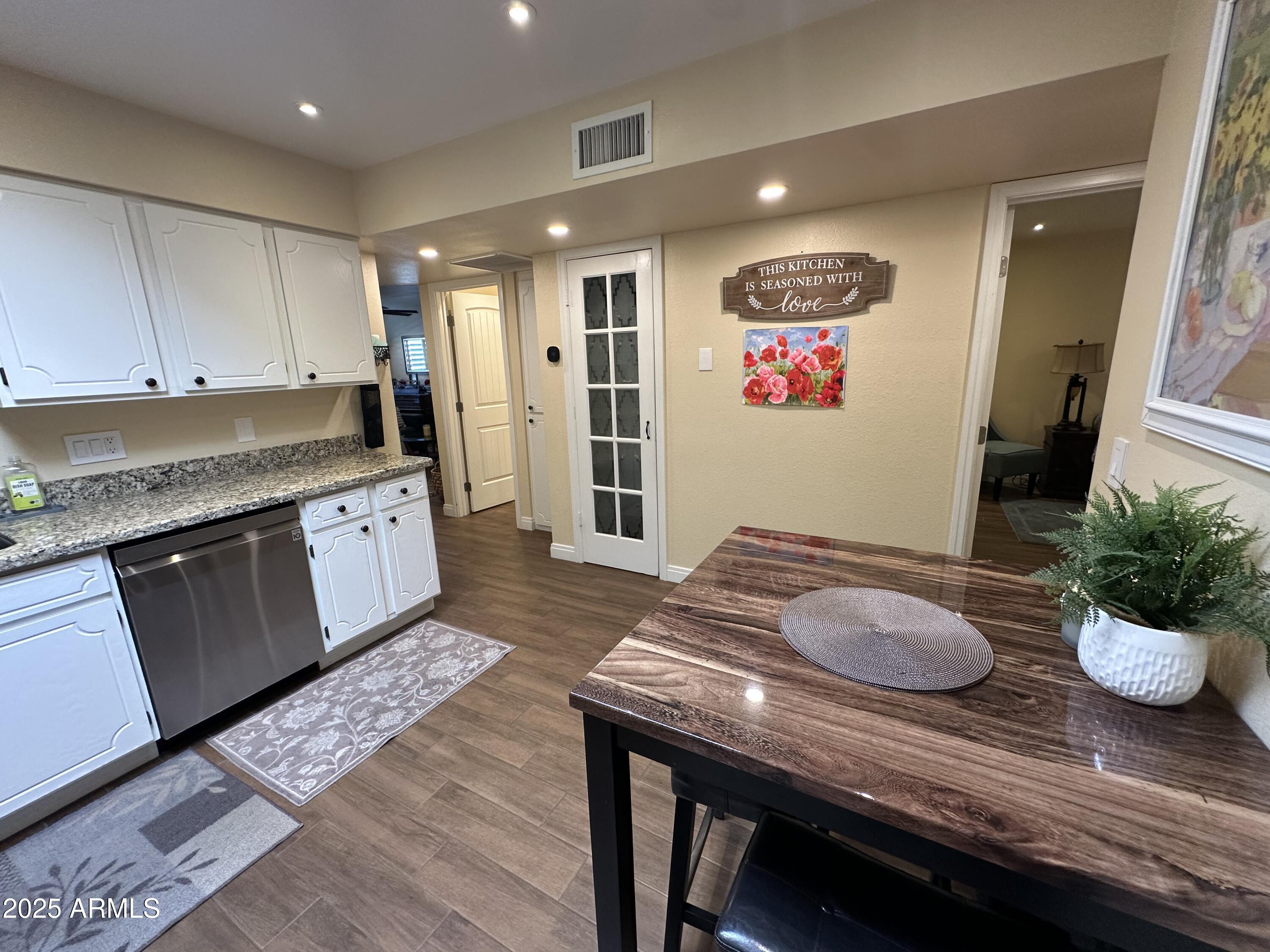 4328 East Capri Avenue, Unit 180 Mesa, AZ 85206 - Photo 12 of 38 a open kitchen with stainless steel appliances granite countertop a stove a sink and cabinets