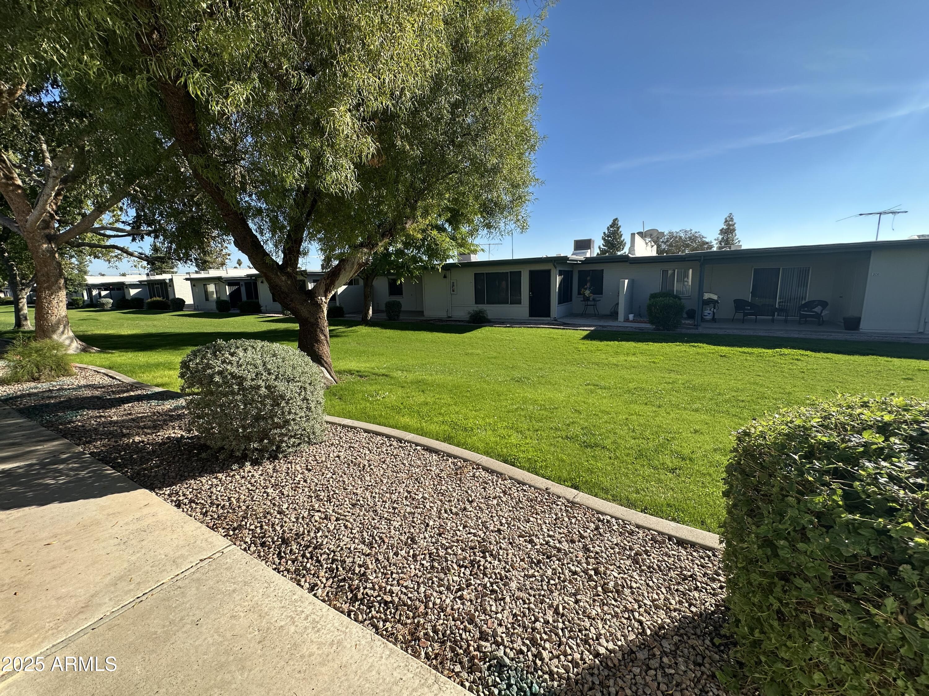4328 East Capri Avenue, Unit 180 Mesa, AZ 85206 - Photo 17 of 38 a view of a backyard with large trees