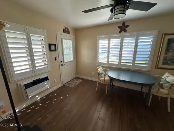 a bedroom with a bed and painting on the wall
