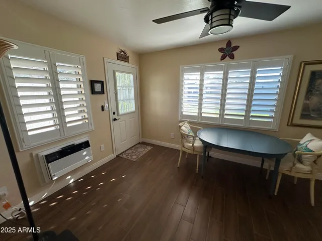 a bedroom with a bed and painting on the wall