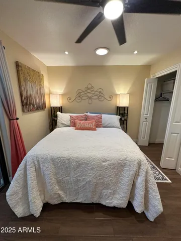 a bed sitting in a bedroom next to a window with pc on the table