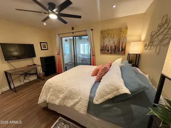 a bedroom with a bed and a flat screen tv