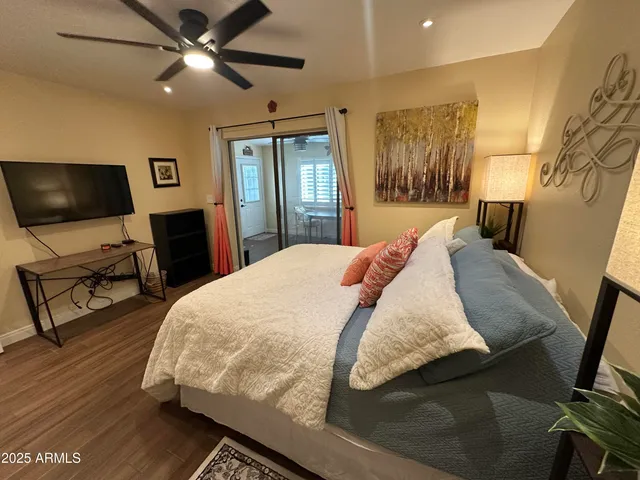 a bedroom with a bed and a flat screen tv