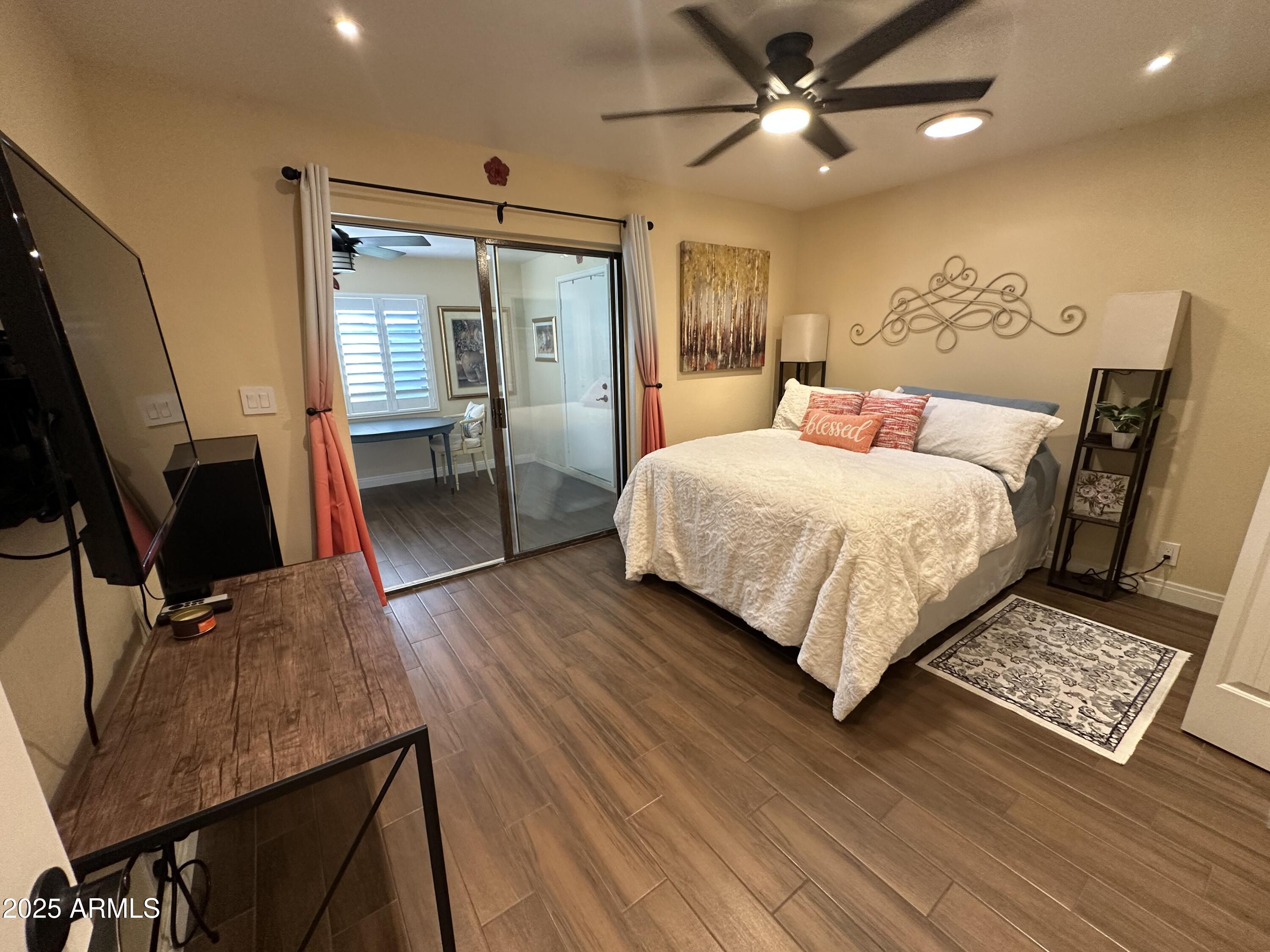 4328 East Capri Avenue, Unit 180 Mesa, AZ 85206 - Photo 24 of 38 a bedroom with a bed window and a flat screen tv