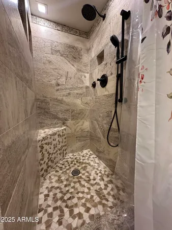 a bathroom with a granite countertop sink a toilet and a mirror