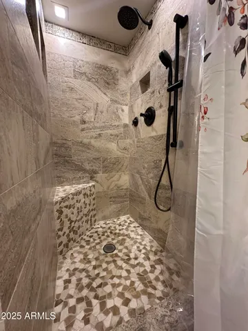 a bathroom with a granite countertop sink a toilet and a mirror