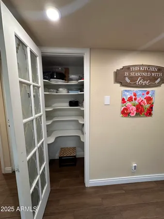 a bathroom with a granite countertop toilet a sink and a mirror